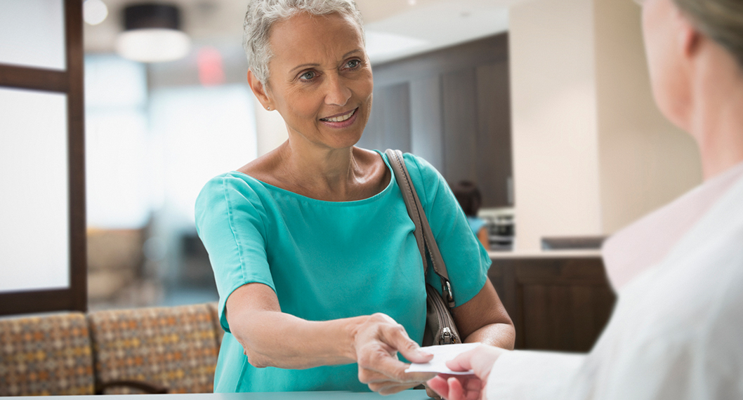 Retiring woman learning how to lower her Medicare Part D costs